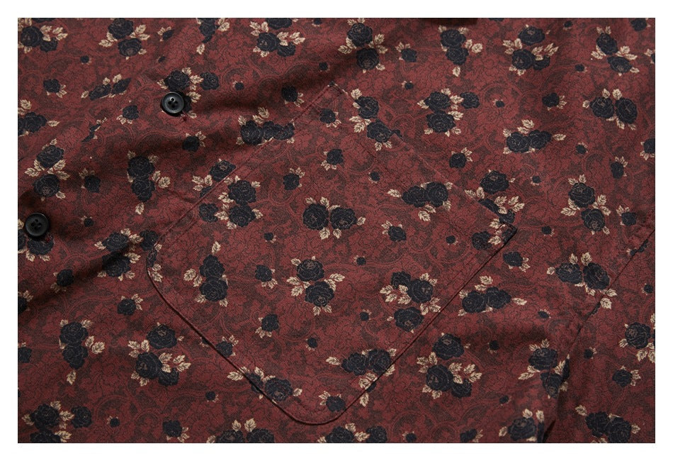 Close-up of a reddish-brown floral shirt showing black buttons and a chest pocket.