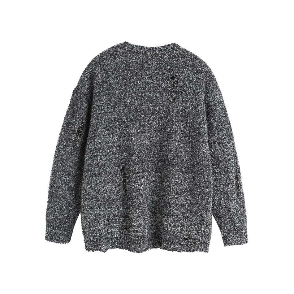 Back view of a charcoal and gray marled sweater with distressed slits and a ribbed hem.