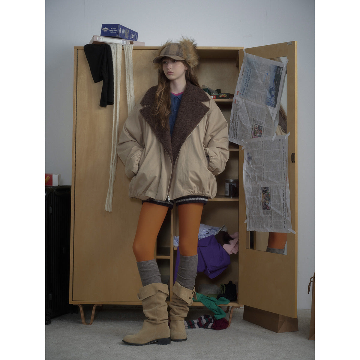 Full-length front view of a model wearing an oversized beige jacket with a dark brown fleece collar.