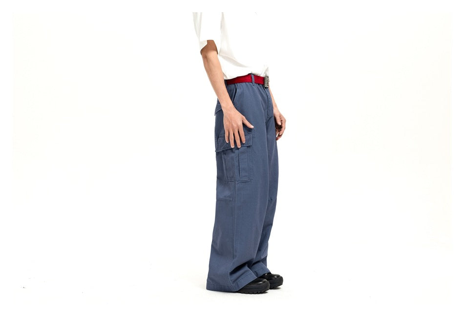 Side view of a model wearing blue wide-leg cargo pants with a large thigh pocket.