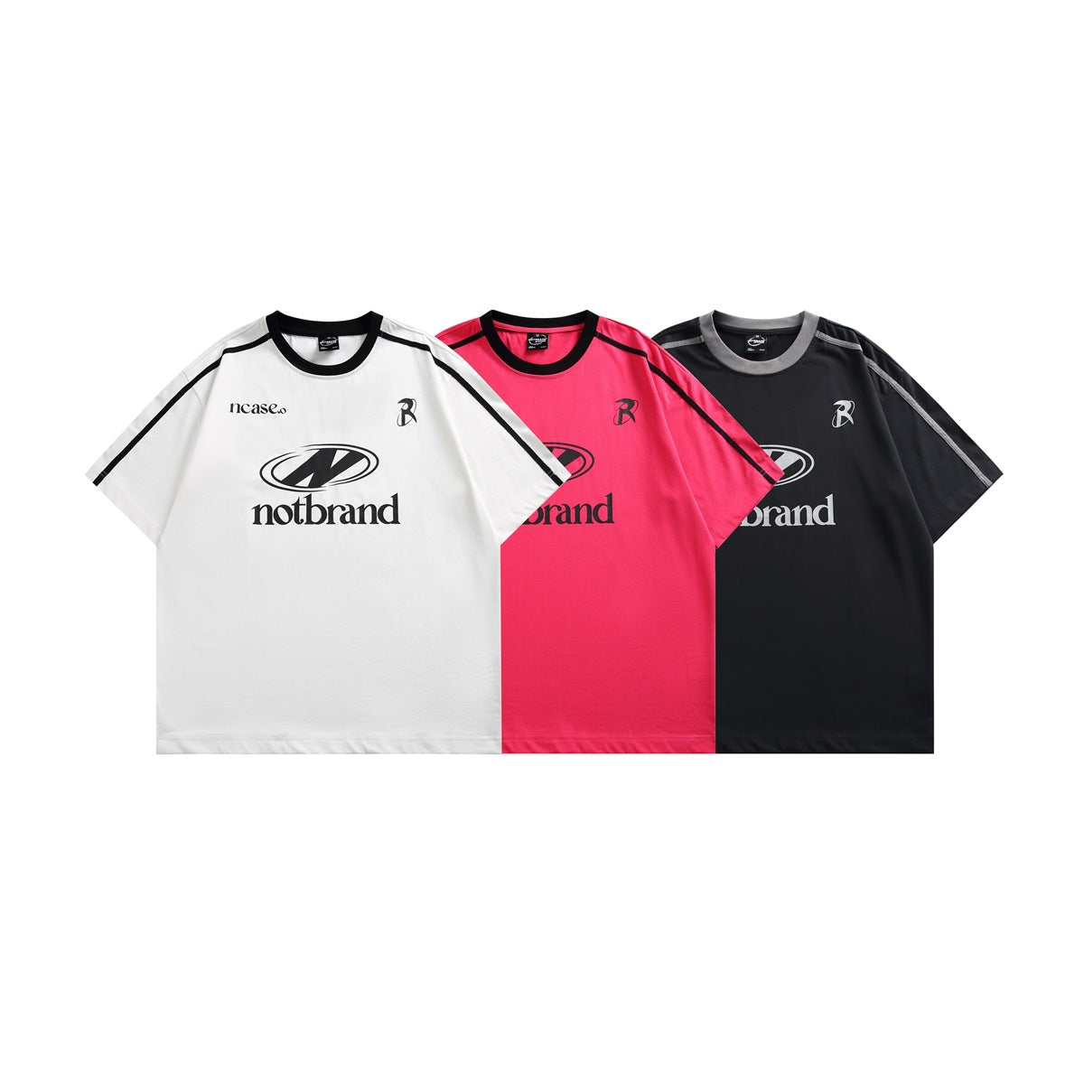 Three short-sleeve graphic T-shirts shown from the front in white, bright pink, and black, each with contrasting shoulder