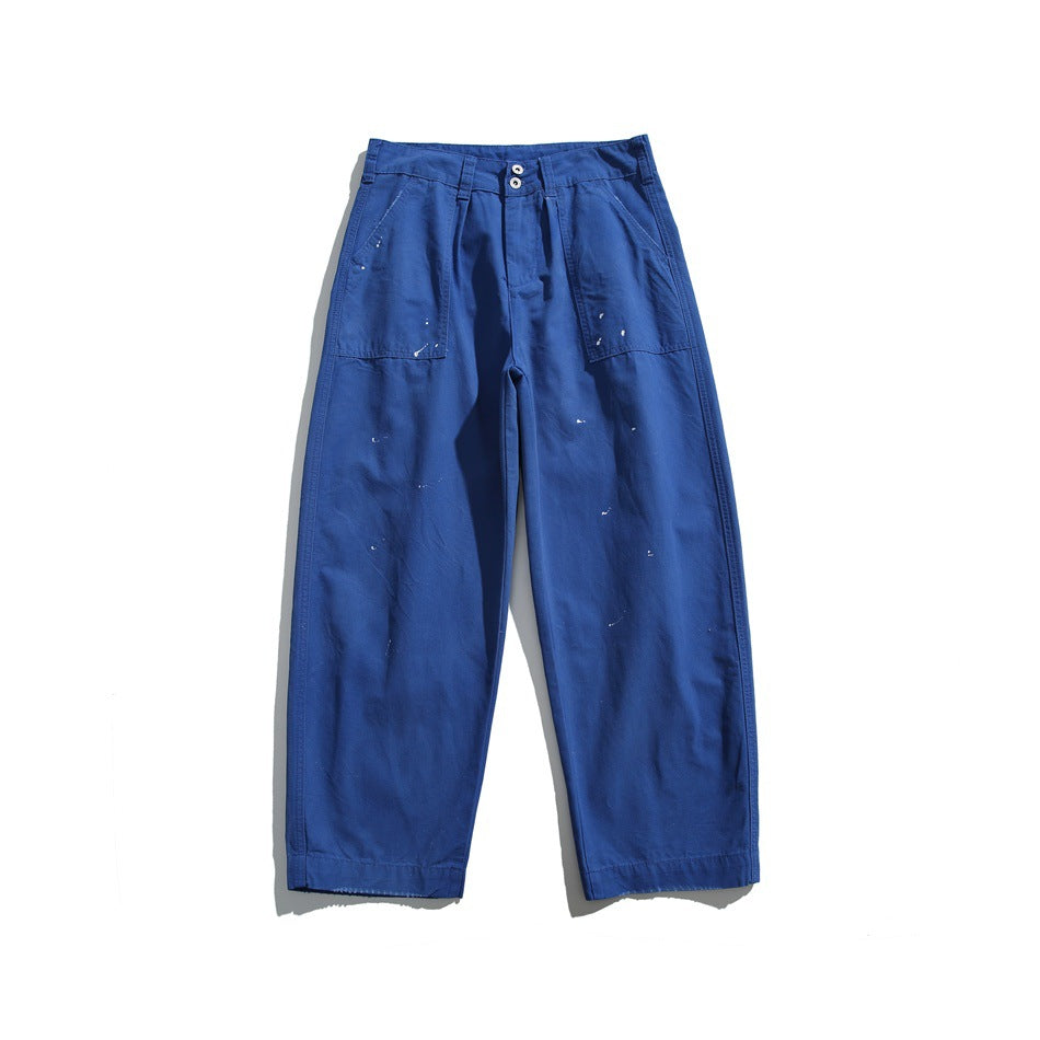 Royal blue wide-leg pants flat lay with white paint splatters, patch pockets and a two-button waistband