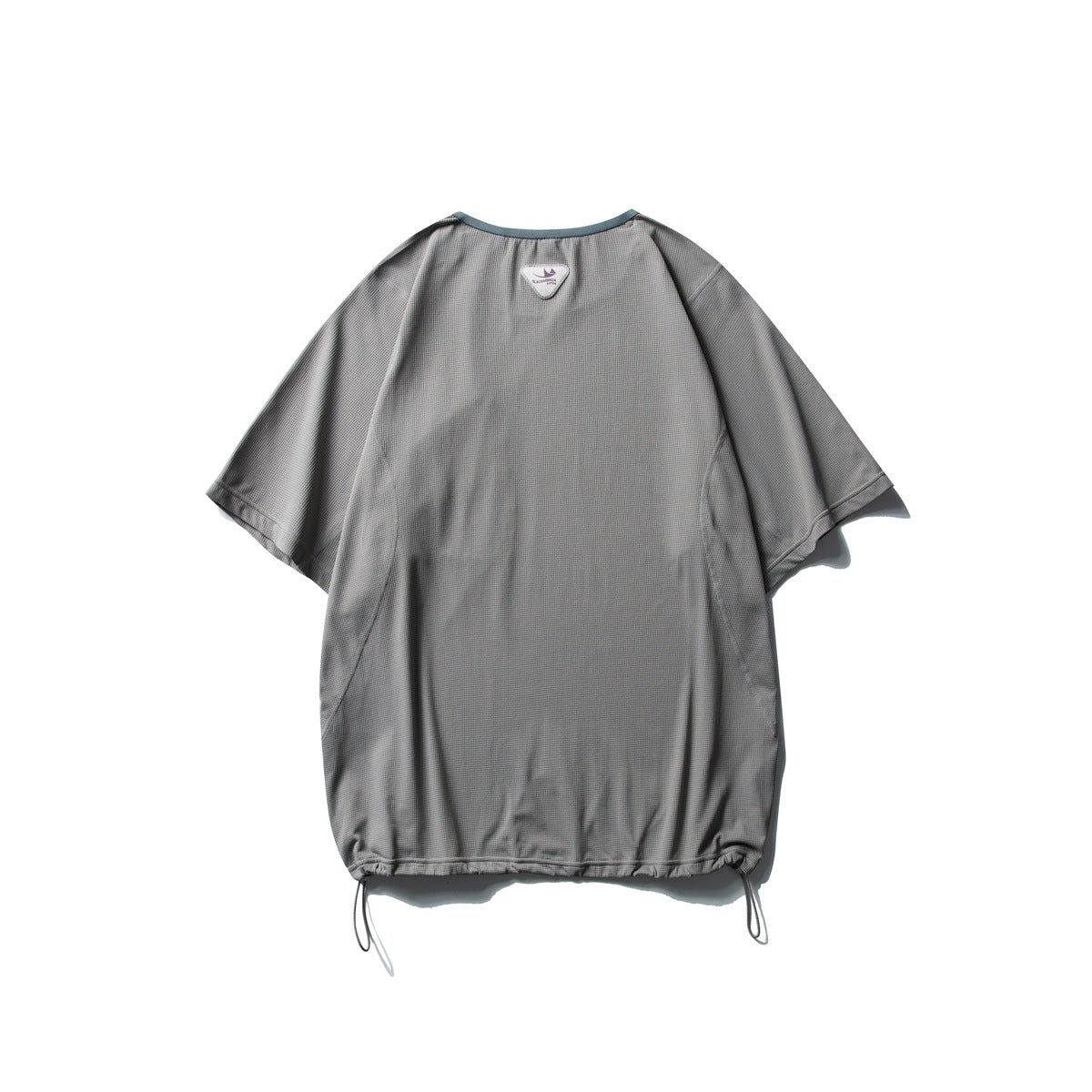 Back of a loose gray short-sleeve top with curved seams, a small neck label and drawcords at the hem.