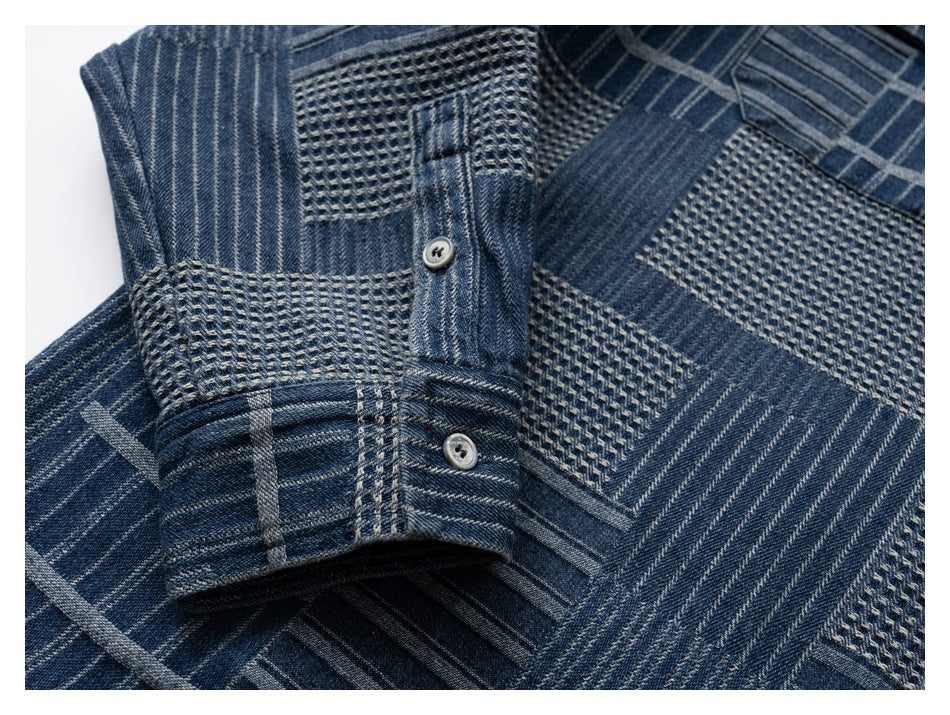 Close-up of the blue patterned shirt’s buttoned sleeve cuff and mixed geometric fabric panels.