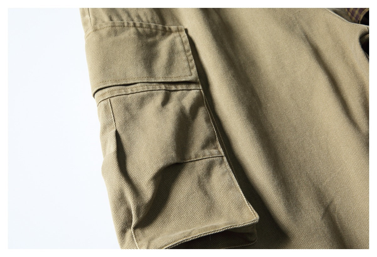 Close-up of a tan twill garment with a large flap cargo pocket.