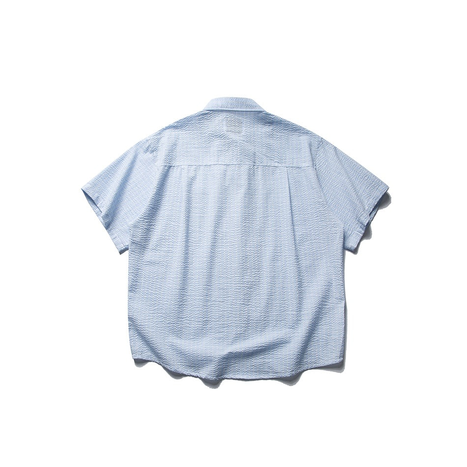 Back view of a light blue short-sleeve button-up shirt with a subtle textured pattern.