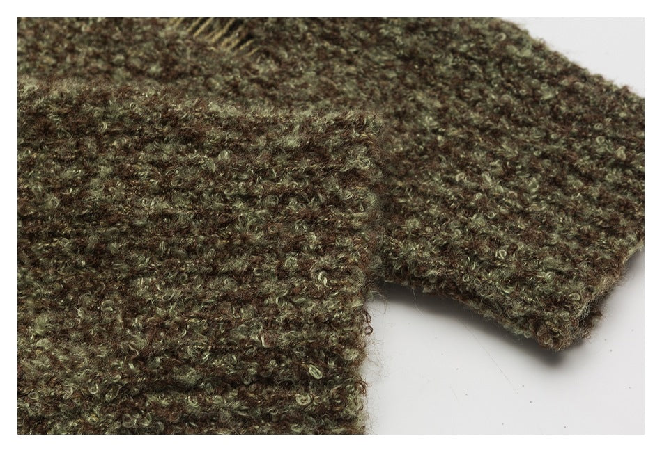 Close-up of textured brown and olive knit at a garment seam and edge.