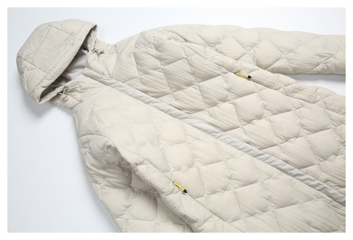Angled close view of an ivory quilted hooded coat, showing the hood, front opening, and yellow zipper pulls.