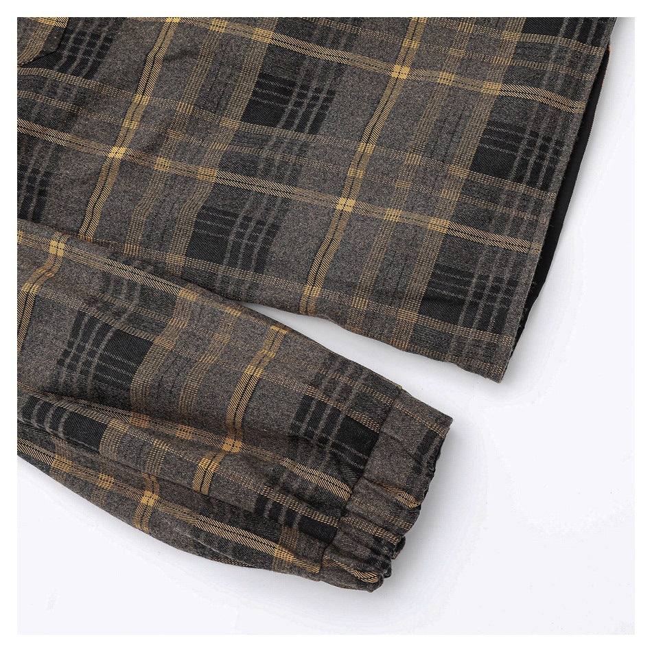 Close-up of the plaid jacket sleeve and gathered button cuff.
