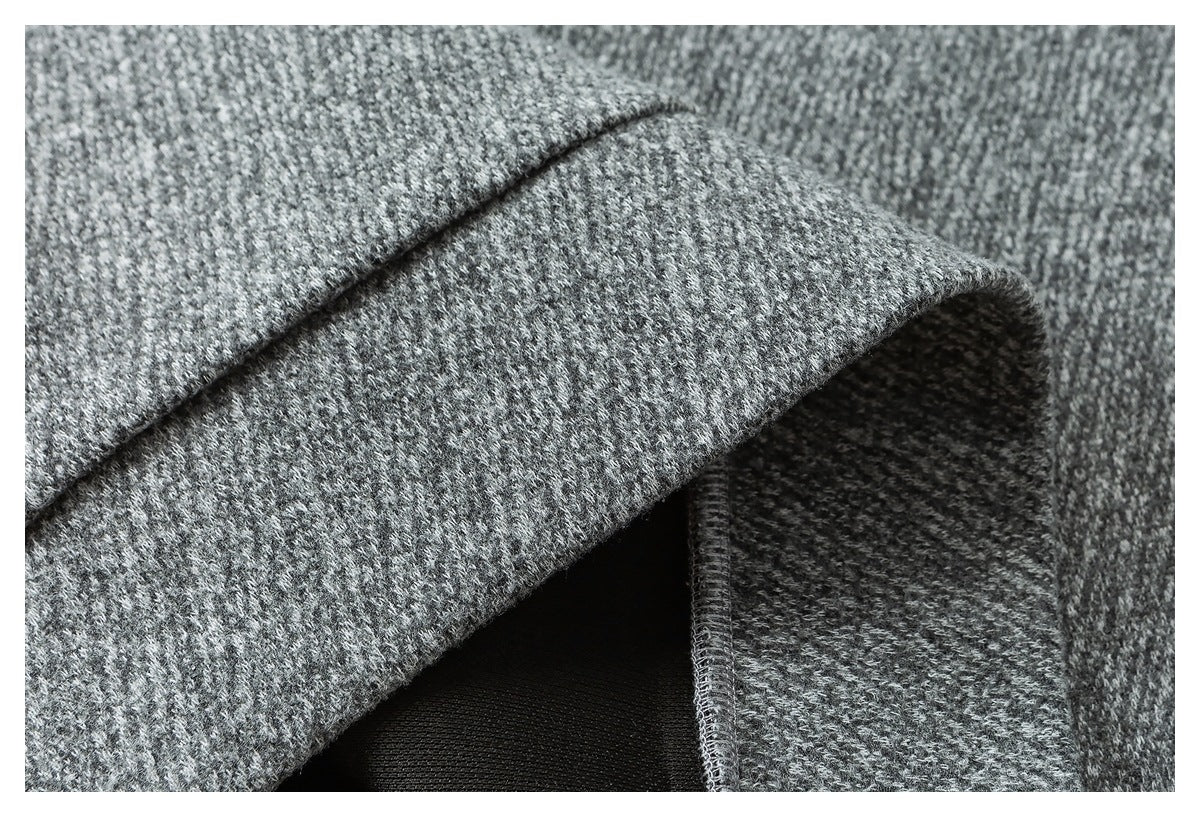 Close-up of a folded gray garment edge showing the seam and dark interior facing.