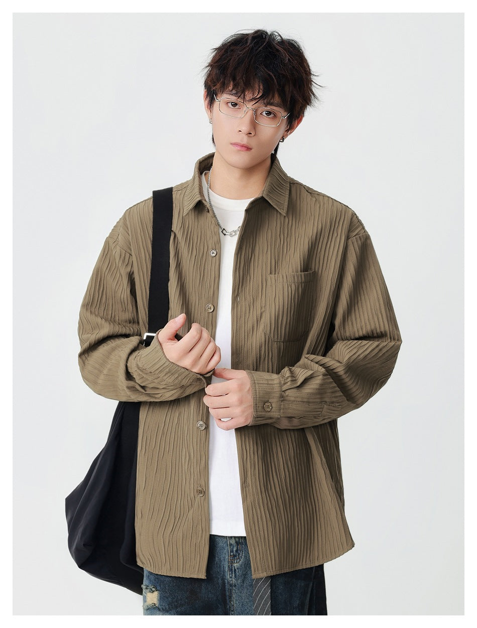 Model wearing an open khaki textured-stripe long-sleeve shirt over a white tee with jeans and a black shoulder bag