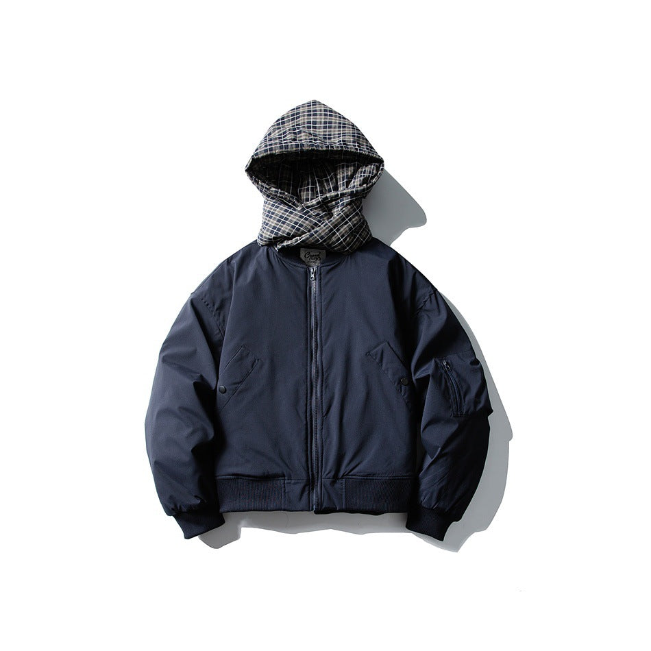 Front view of a navy zip-up jacket with a black-and-white plaid hood, angled pockets, and ribbed trim.