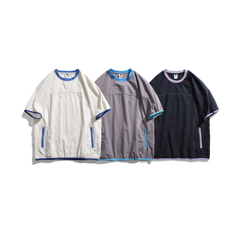 Three short-sleeve shirts shown together in ivory with blue trim, gray with cyan trim, and navy with lavender trim.