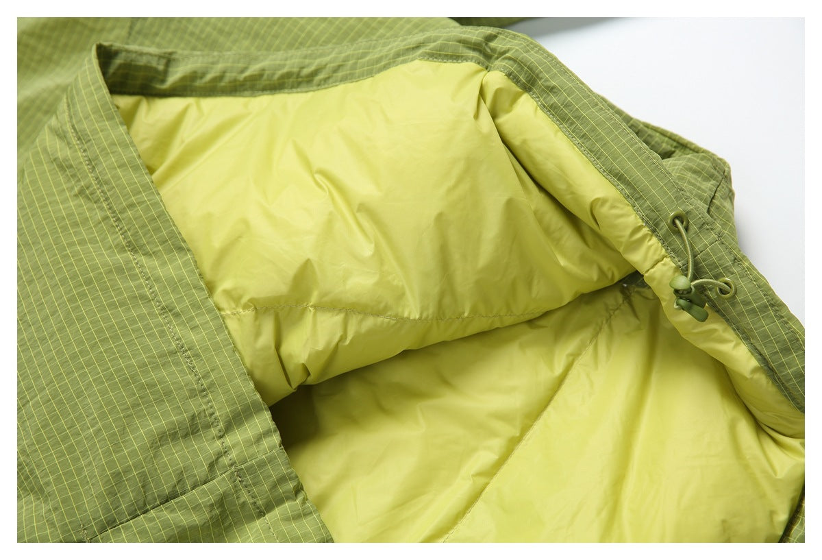 Close-up of the jacket's pale yellow-green lining and an adjustable drawcord at the edge.