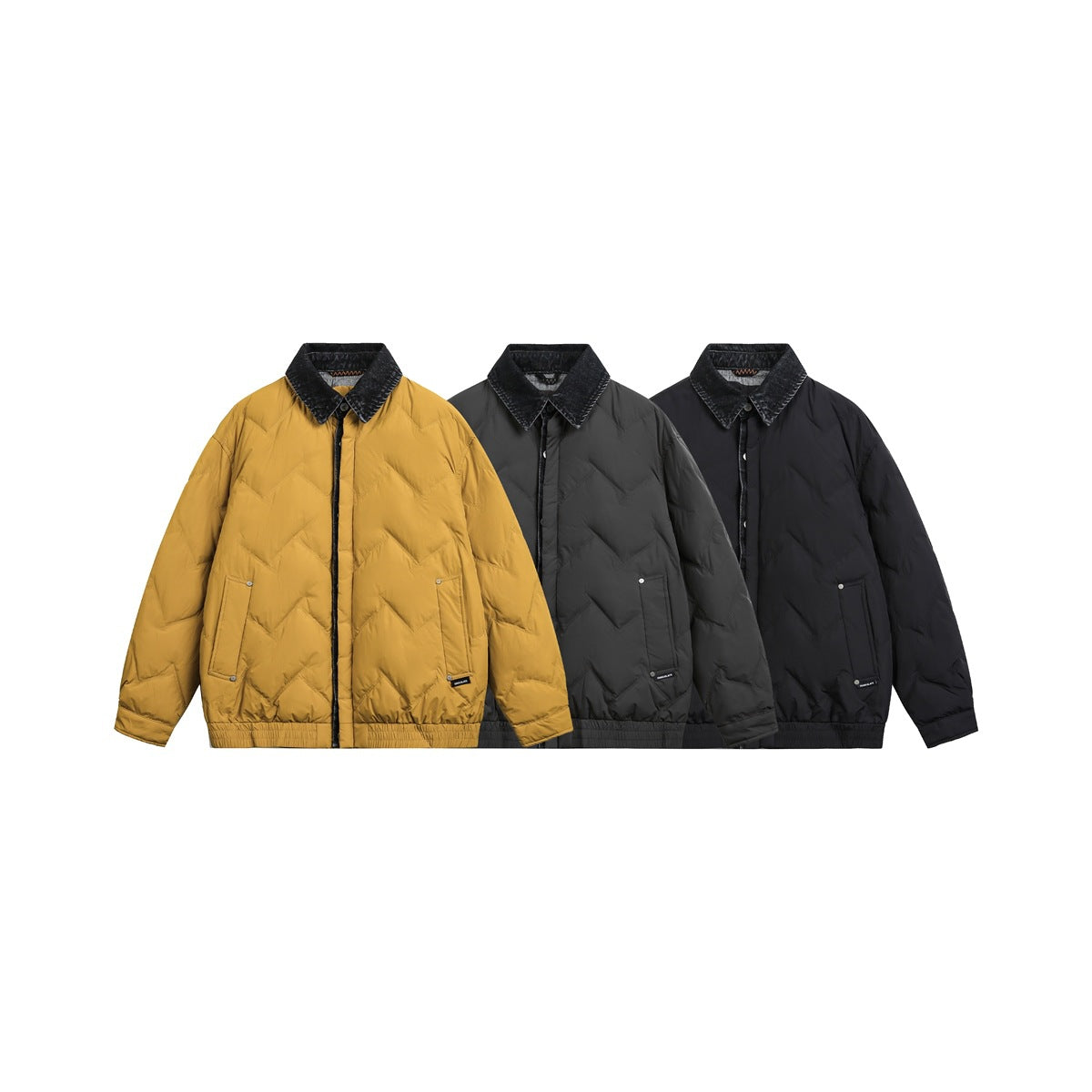 Three chevron-quilted jackets shown together in mustard yellow, charcoal gray, and black.