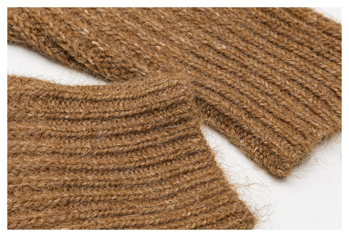 Close-up of brown knit garment panels with finished edges and visible stitching.
