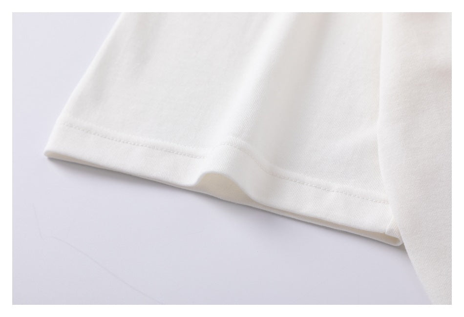 Close-up of a white shirt sleeve with a stitched hem.