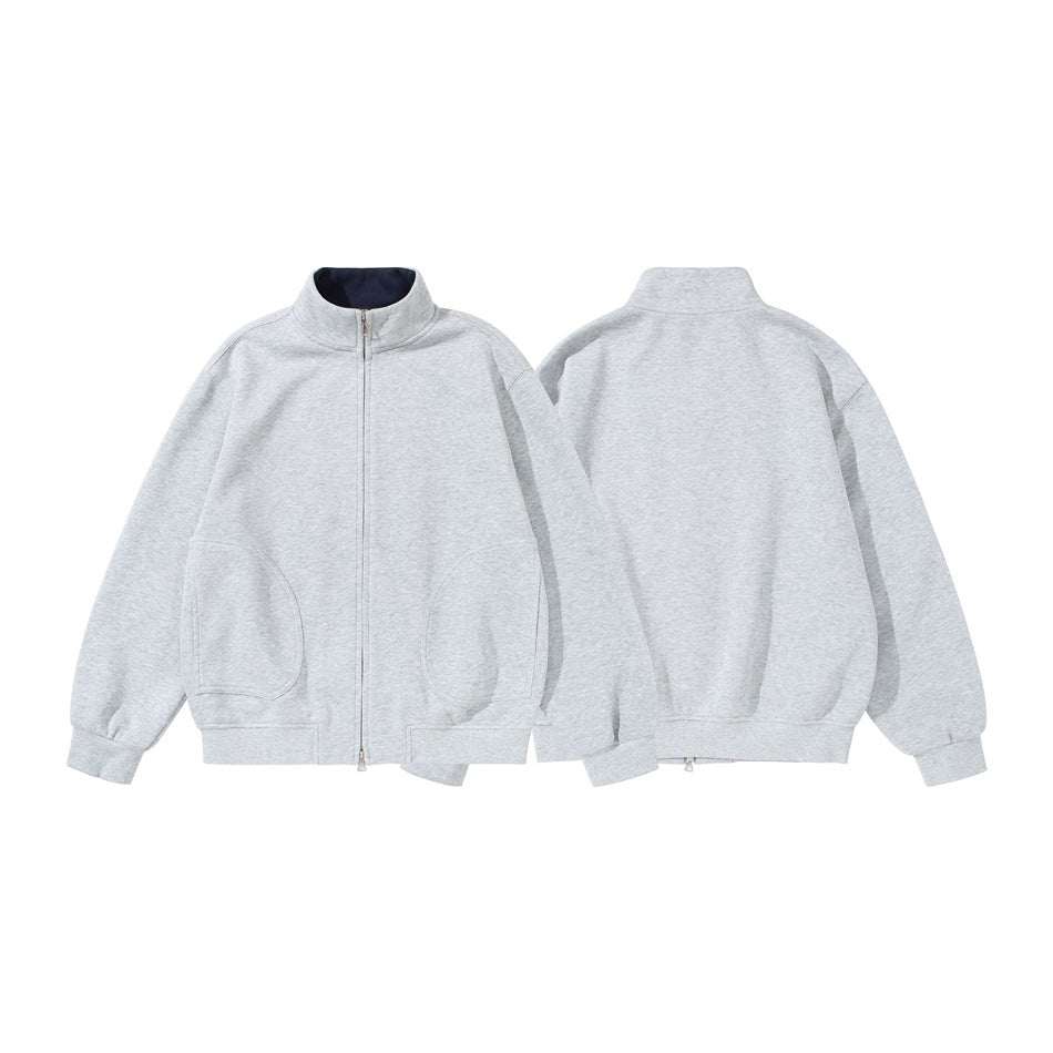 Light gray zip-up jacket shown from the front and back, with a stand collar, ribbed cuffs, and curved front pockets.