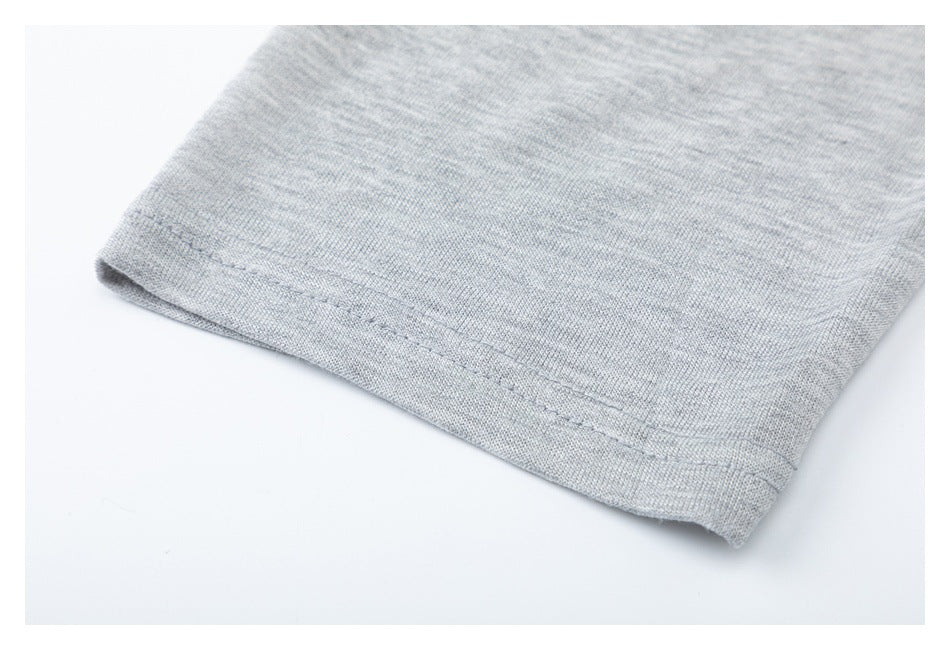Close-up of the double-stitched cuff edge on a light gray heather knit sleeve.