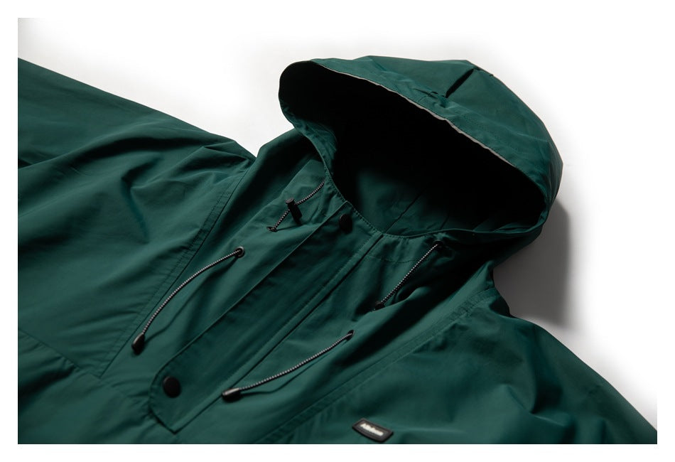 Close-up of a dark teal hooded jacket laid flat, showing the hood, front placket, and adjustable drawcords.