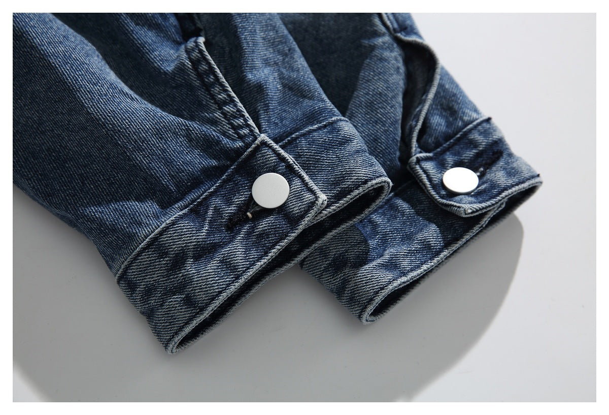 Close-up of blue denim cuffs with silver snap buttons.