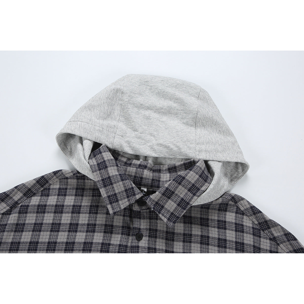 Close-up of a gray hood and collar on a black-and-gray plaid button-up shirt.