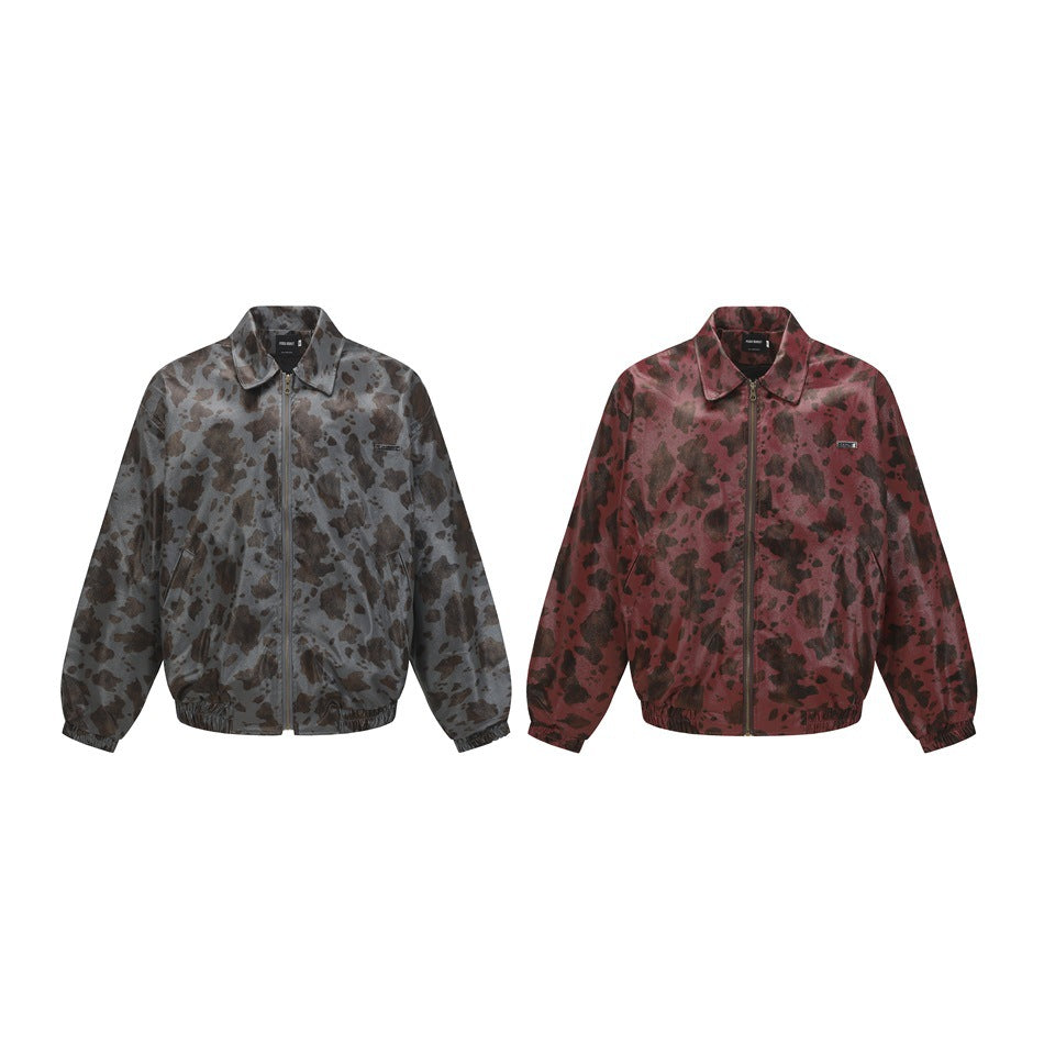 Two front-facing jackets on white: one charcoal gray and one burgundy, both with dark mottled patterns and zip fronts.