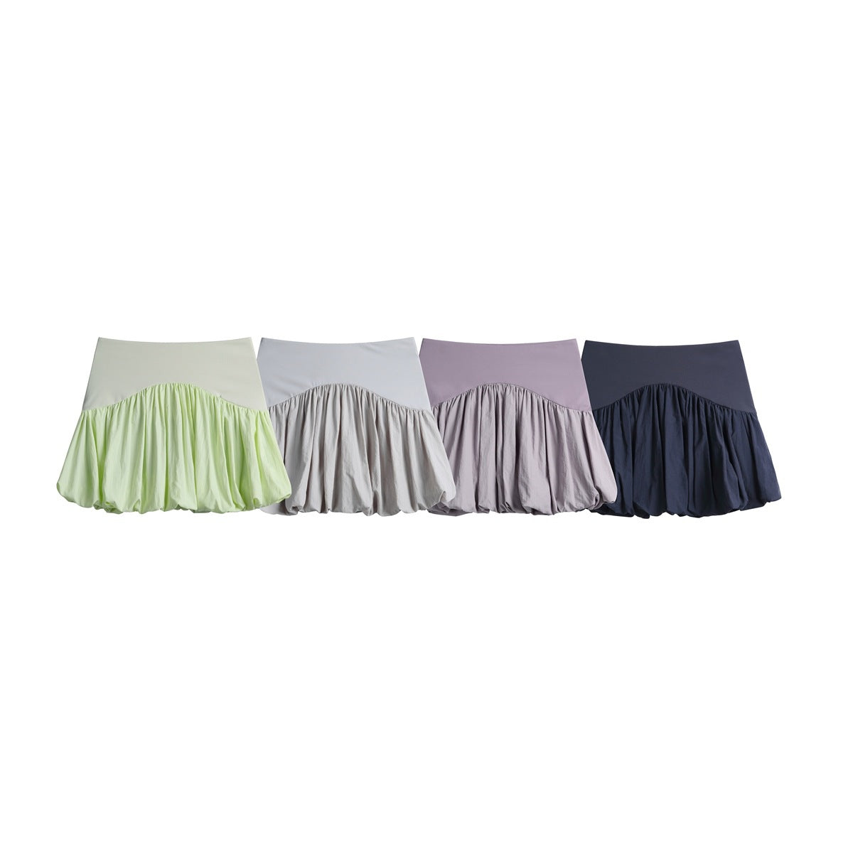 Four bubble skirts displayed together in pale green, light gray, lavender, and dark navy.