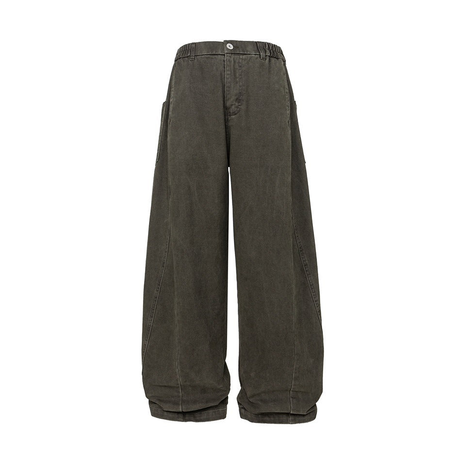 Front view of loose, wide-leg charcoal gray trousers with a button waist and curved leg seams.