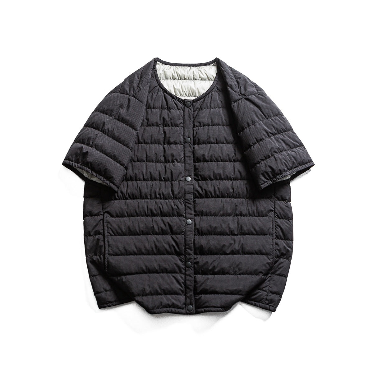 Black quilted short-sleeve jacket with round neckline and snap buttons, flat lay front view