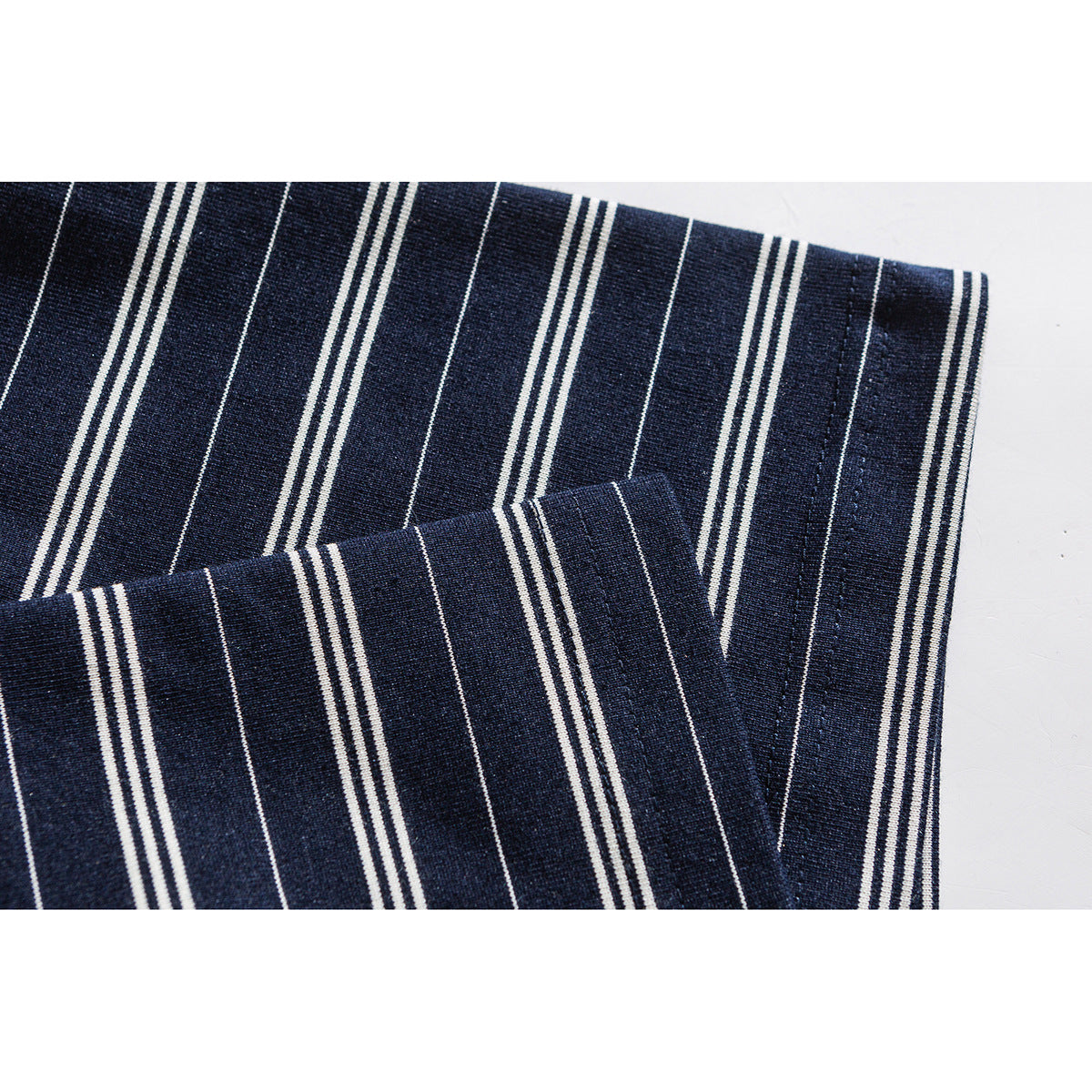 Close-up of a navy-and-white striped shirt sleeve and cuff.