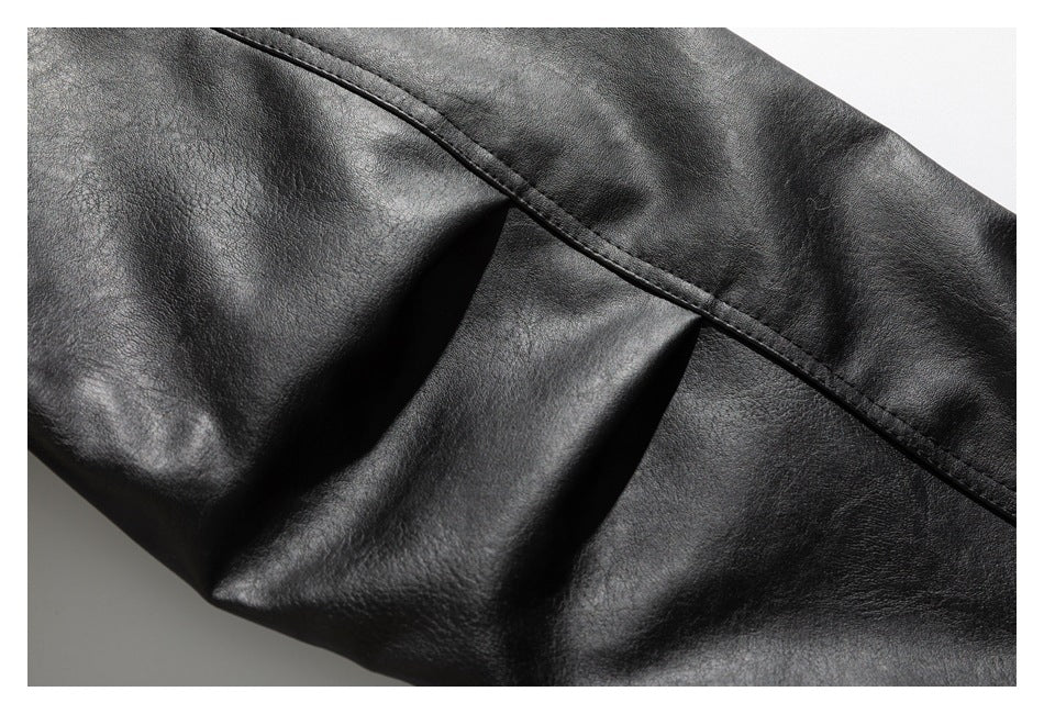 Close-up of a stitched seam and gathered folds in black jacket material.