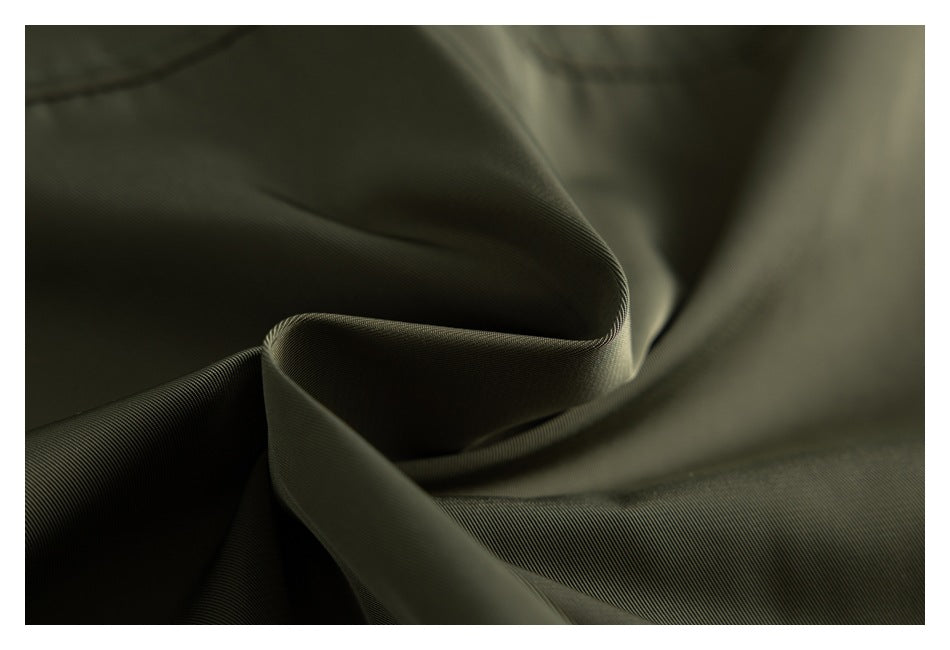 Close-up of olive fabric draped into soft folds, showing its fine surface texture.