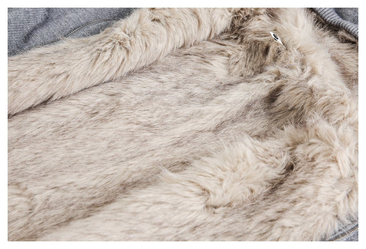 Close-up of the garment’s beige fluffy lining beside gray knit fabric and a zipper edge.