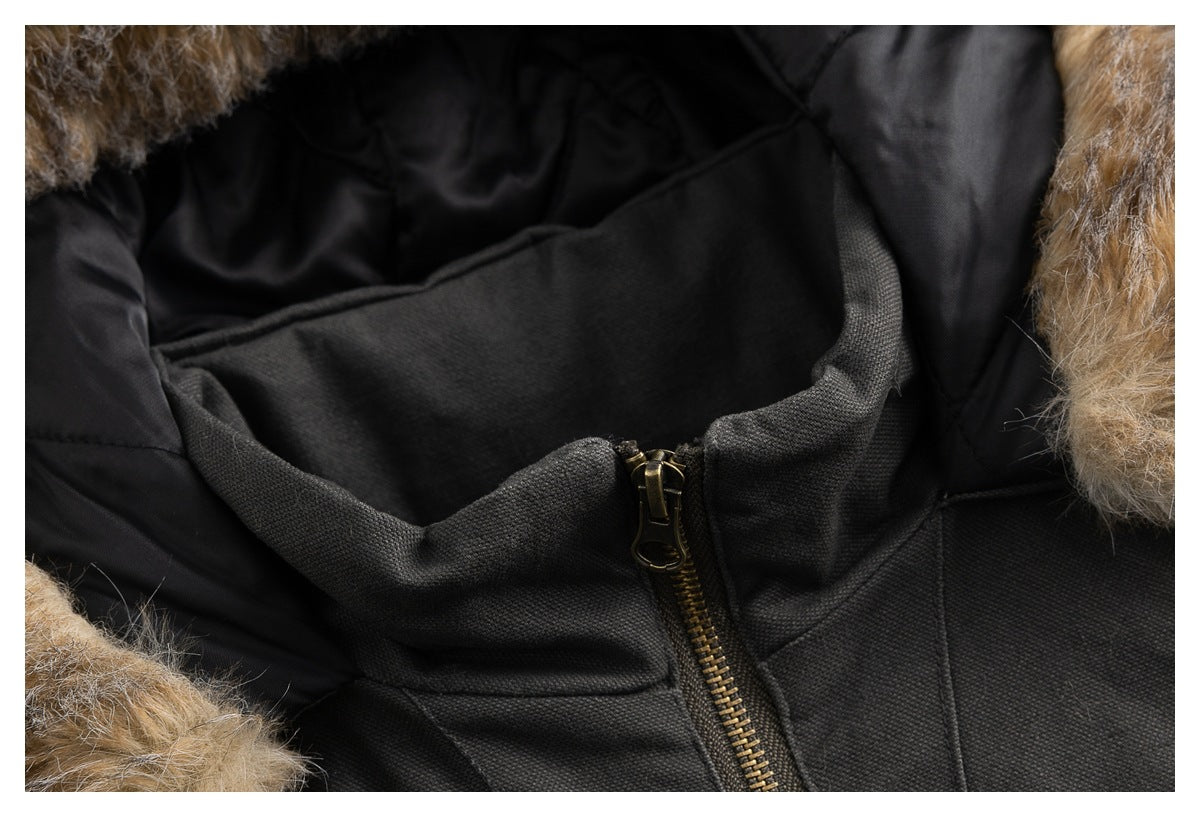 Close-up of a dark jacket collar with tan faux-fur trim, black lining and an antique-brass zipper.