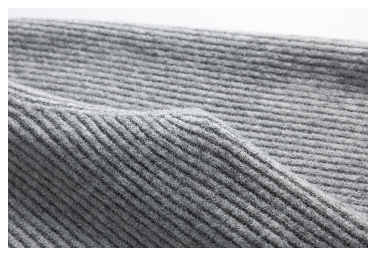 Close-up showing the raised ribbed texture of gray knit fabric.