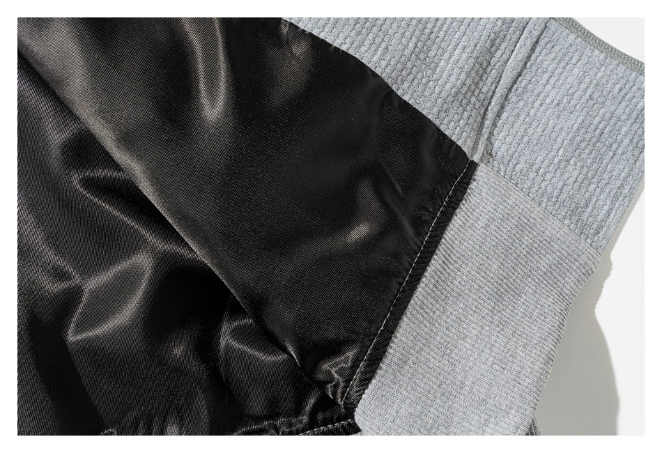 Close-up of black inner fabric meeting a light gray textured knit panel.