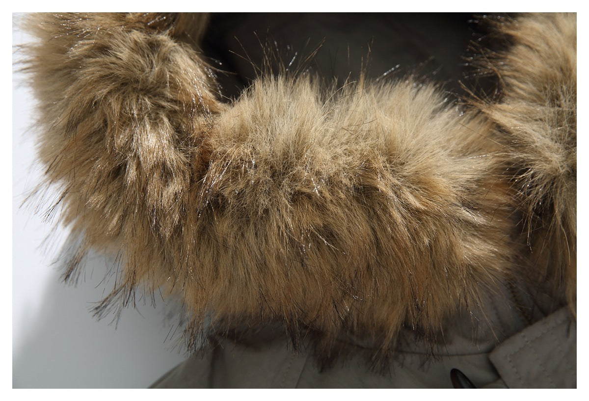 Close-up of a taupe jacket hood edged with thick tan and brown fur trim.