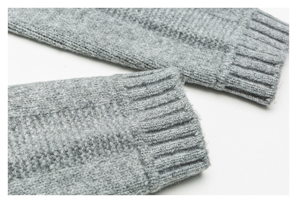Two gray knitted sweater sleeves with ribbed cuffs, shown close-up on white.