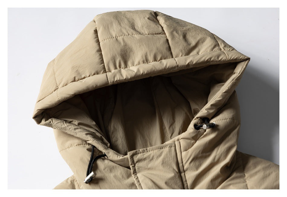 Close-up of the tan jacket's quilted hood, lining, and adjustable drawcord toggles.