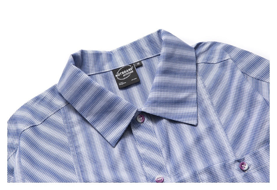 Upper front of a blue-and-white fine-check button-up shirt with a pointed collar and purple-toned buttons.