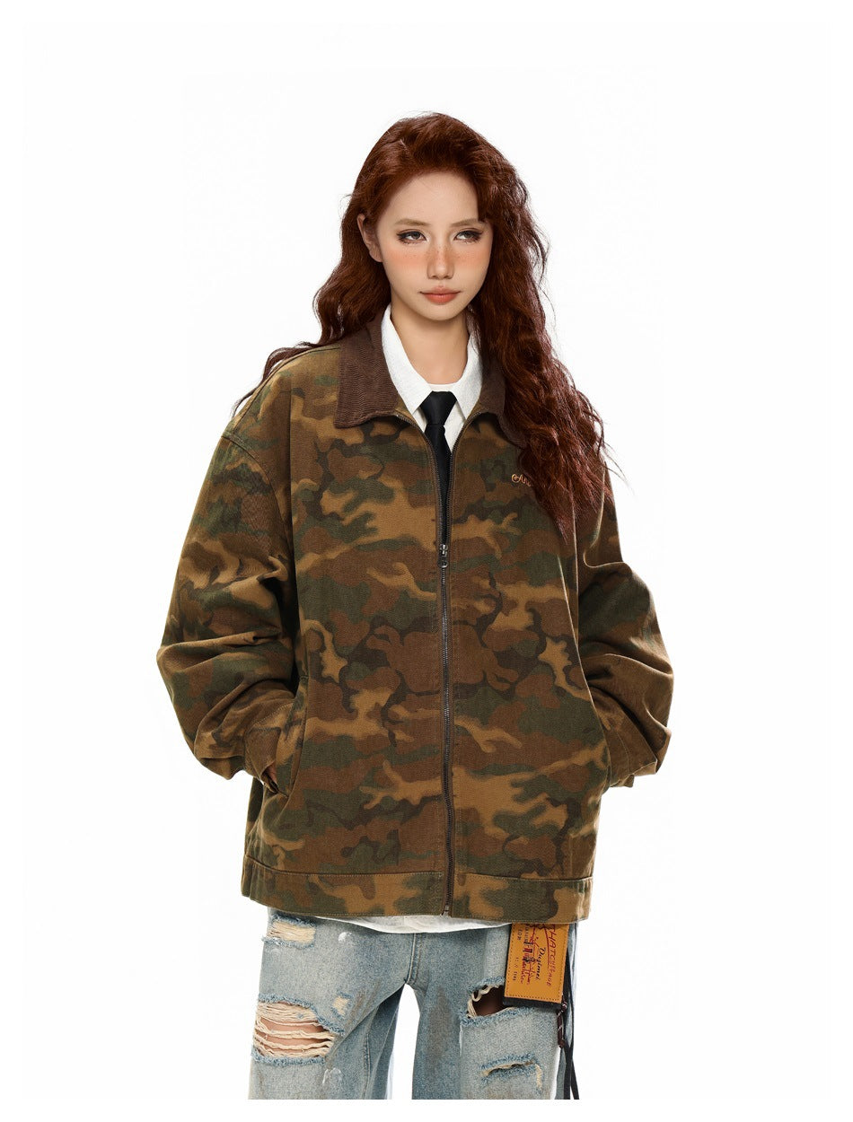 Model wearing an oversized brown and olive camouflage zip jacket with a dark corduroy collar.