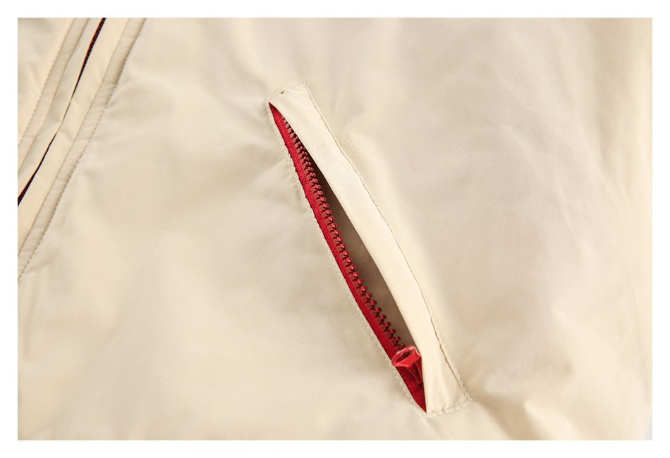 Close-up of a red zipper pocket set into the cream jacket.