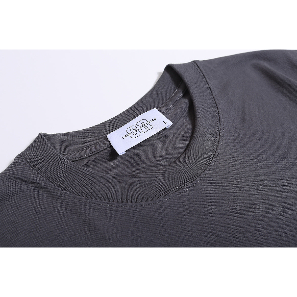 Close-up of a charcoal-gray T-shirt’s ribbed crew neckline and sewn-in label.