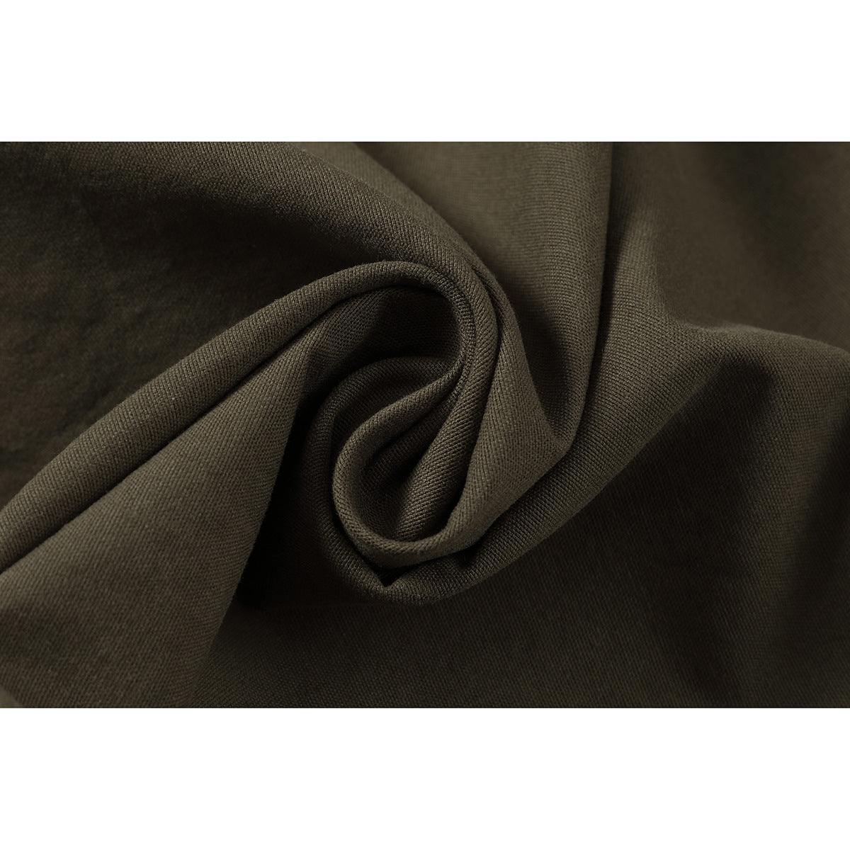Close-up of dark olive fabric gathered into folds, showing its surface texture.