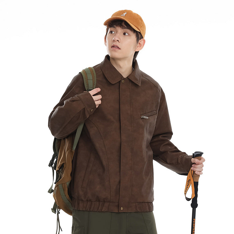 Model wearing a brown collared jacket with a snap-front closure, angled zip chest pocket, and elastic hem.