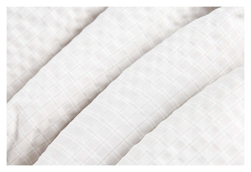 Close-up showing the fine white and pale gray check pattern and raised texture of the fabric.