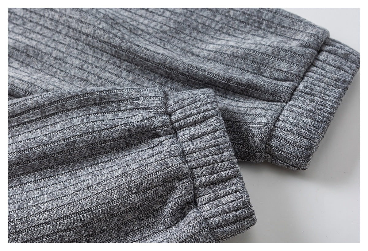 Close-up of heather gray knit fabric and its wide ribbed cuff or hem.