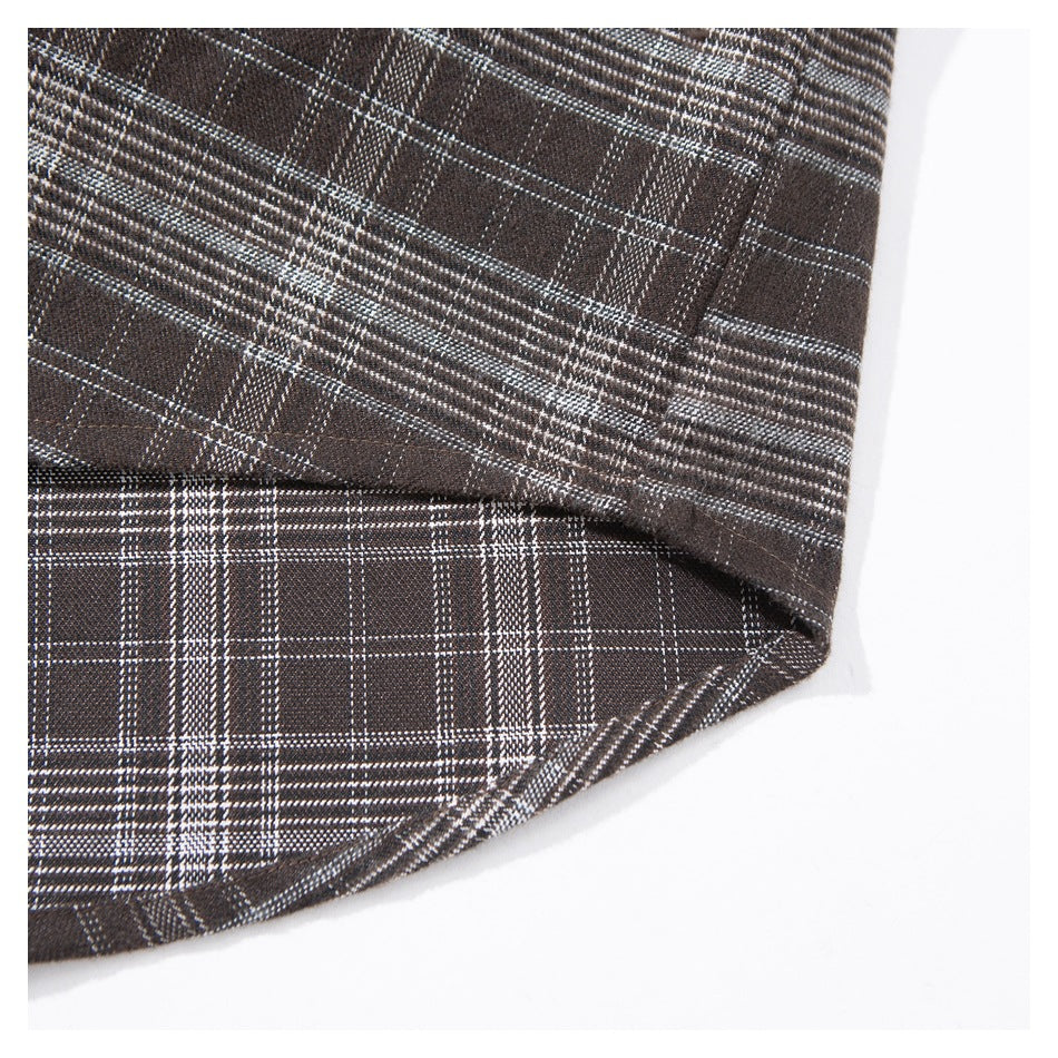 Close-up of the hem and overlapping panels of a dark brown plaid shirt.