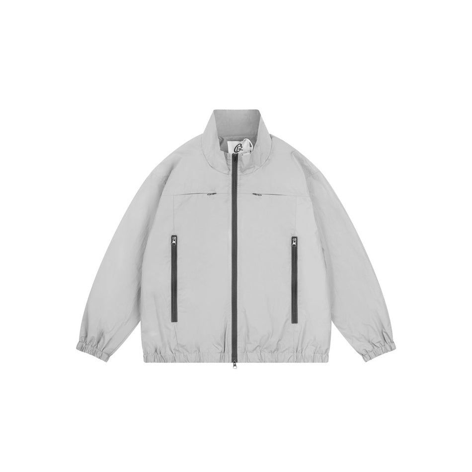 Gray stand-collar zip jacket with dark front zipper, zippered pockets and elastic cuffs and hem, flat front view